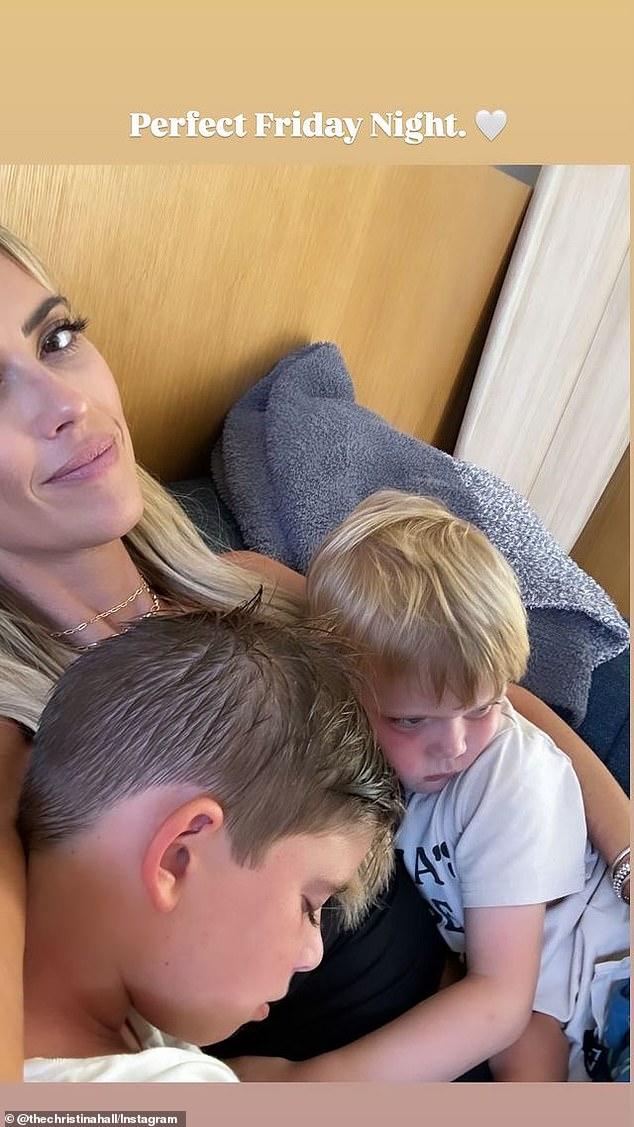 Later that night, she uploaded a sweet snap of herself snuggled on the couch with her sons Brayden, eight, and Hudson, four.