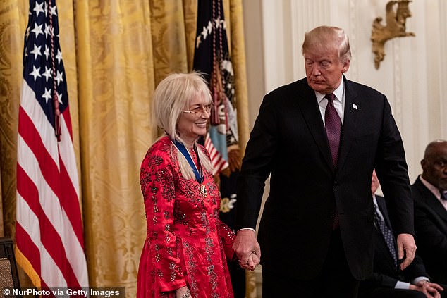 U.S. President Donald Trump presents physician Miriam Adelson, wife of Sheldon Adelson, with the Presidential Medal of Freedom on November 16, 2018.