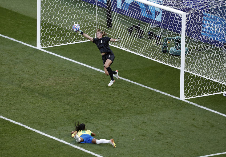 U.S. national team goalkeeper Alyssa Naeher dives to save a shot in overtime during the women's gold medal match against Brazil. (REUTERS/Benoit Tessier)