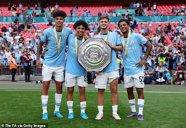 Bobb (right) pictured posing with the Community Shield alongside (left to right) Nico O'Reilly, Rico Lewis and James McAtee