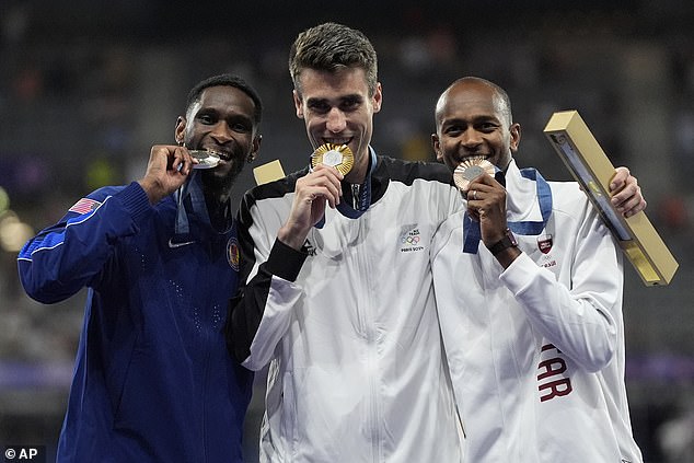 Qatar's Mutaz Barshim (right) took bronze. Shelby McEwen (left) took silver.