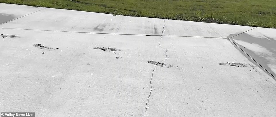 Footprints can be seen on the concrete path from when workers walked on it before it dried.