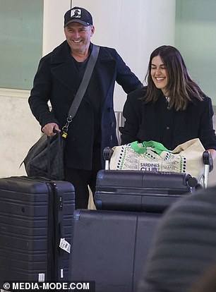 Karl, 49, and Sarah, 38, were all smiles as they touched down on home soil at Sydney Airport, looking happy and fresh-faced after the 20-plus hour flight.