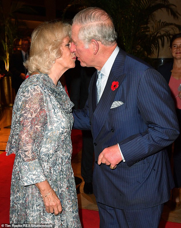 The king of romance! Charles greets Camilla with a tender kiss during a visit to Merlion Park in Singapore in 2017. It was at the start of their 11-day trip through Southeast Asia and India and the couple hadn't seen each other for a few days.