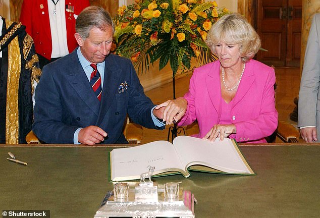 Camilla gently places her hand on Charles's at a reception to mark Cardiff's 50th anniversary as the capital and its centenary as a city, in July 2005. The ceremony took place just three months after the couple were married.