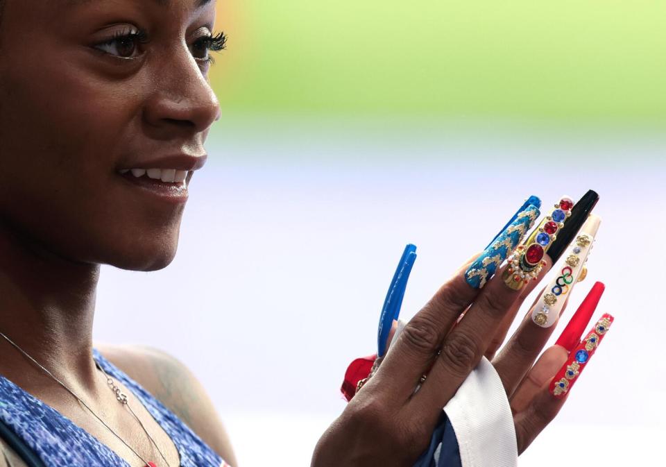 American Sha'carri Richardson shows off her long nails after winning gold in the 4X100 relay at the