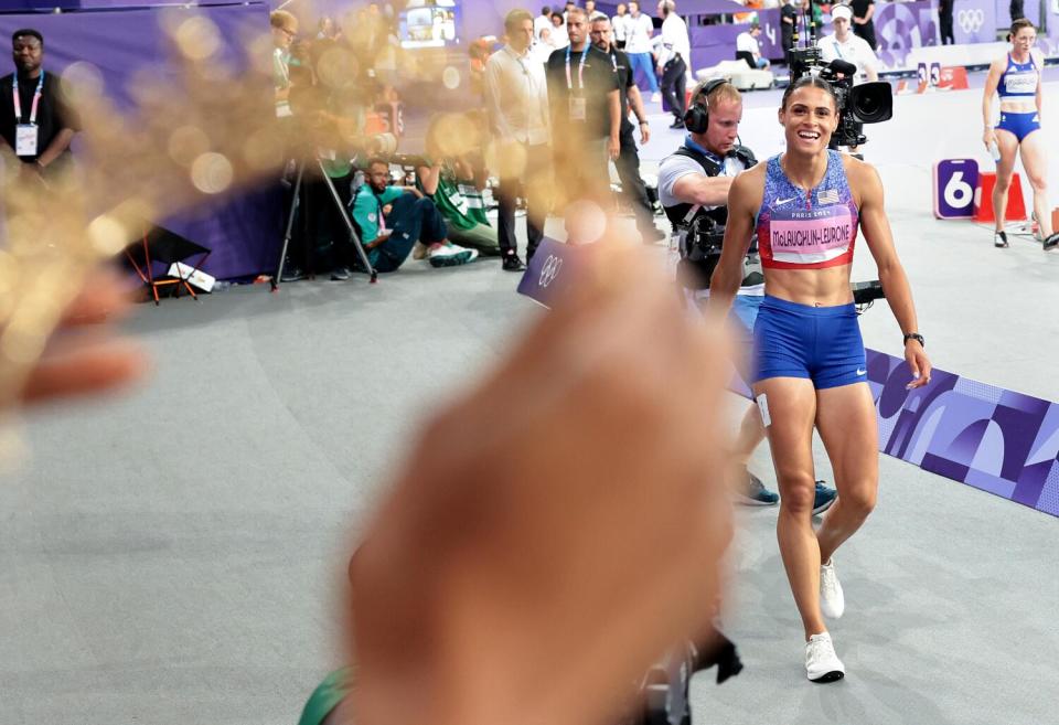 -American Sydney McLaughlin-Levrone receives a crown from her sister after winning the