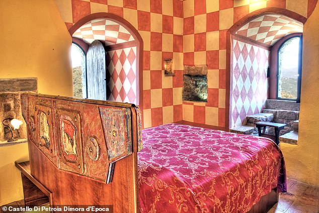 The bedroom in the medieval tower of Castello Di Petroia Dimora d'Epoca overlooks the entire valley: guests will feel as if they are sleeping in the Middle Ages. The Umbrian castle has been home to many Italian nobles over the years.