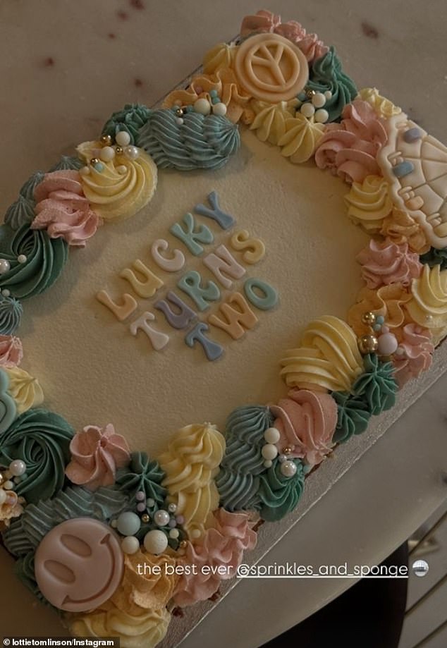 The doting mom also made sure to show off the beautiful birthday cake that featured smiley faces, multi-colored frosting, and edible pearls and beads.