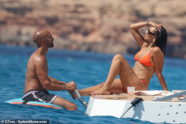 This morning, Rochelle showed off her slender figure in a tiny orange bikini.