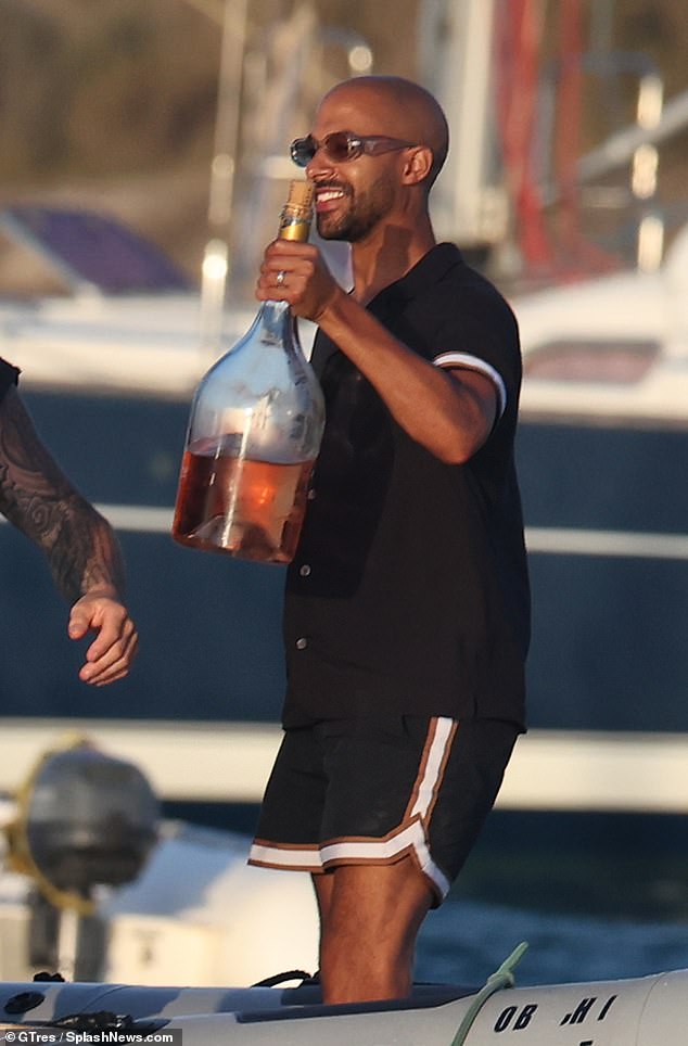 Marvin arrived on the ship carrying a huge bottle of wine for the celebrations while everyone partied on deck.