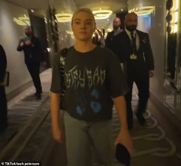 Tash Peterson, 30, was informed of her ban from entering Perth Crown Towers just two hours after she and her boyfriend checked in (pictured, Crown security guards escorting Ms Peterson out).