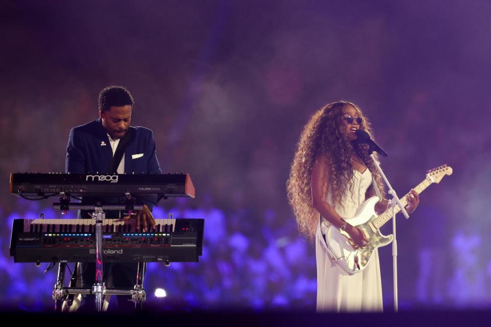 HER performs the United States national anthem during the closing ceremony of the Paris 2024 Olympic Games at the Stade de France