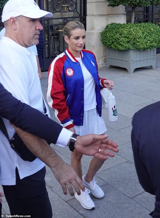 Her jacket, which was adorned with an American flag logo, was paired with an all-white sporty look consisting of a simple T-shirt and a pleated tennis-style skirt.