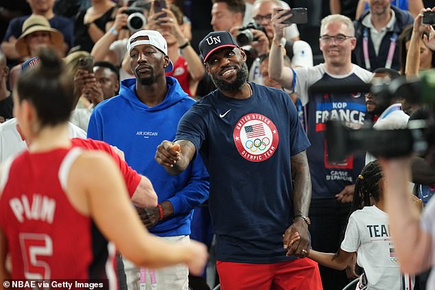 Bam Adebayo and LeBron James (right) watch the Americans win gold in Paris