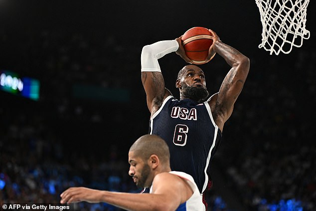 NBA forward Nic Batum did well to get out of the way as James slid in for an easy dunk.