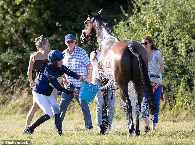 The mother of three was not afraid to get her hands dirty and washed her horse with a bucket of water.