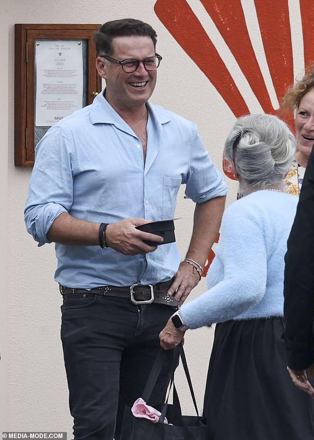 Karl shared a hearty laugh with his loved ones outside the restaurant.