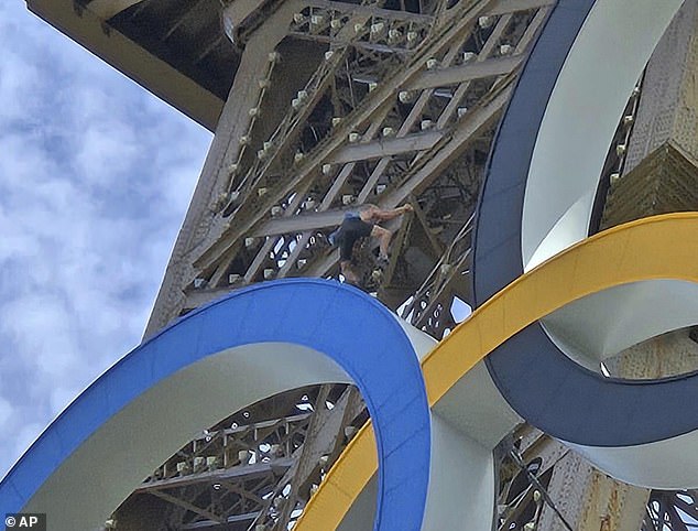 Davis was seen just above the Olympic rings that adorn the second section of the monument.