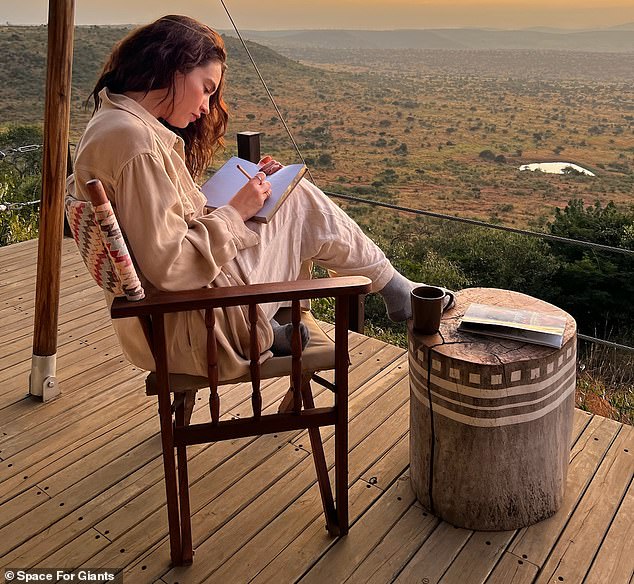 The English actress put her feet up and wrote in her diary in the images taken just before sunset.