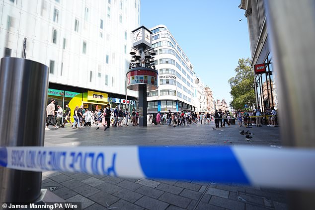 The cordon is next to the LEGO store and in front of the M&M store, and families and tourists still queue for each