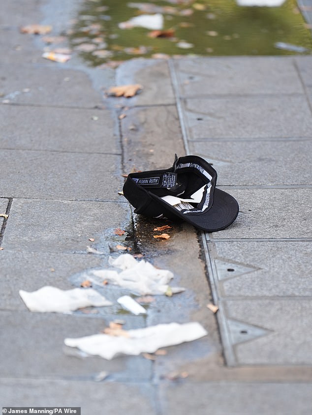 A baseball cap is seen at the scene in Leicester Square, London, where a man was arrested after an 11-year-old girl and a 34-year-old woman were stabbed.