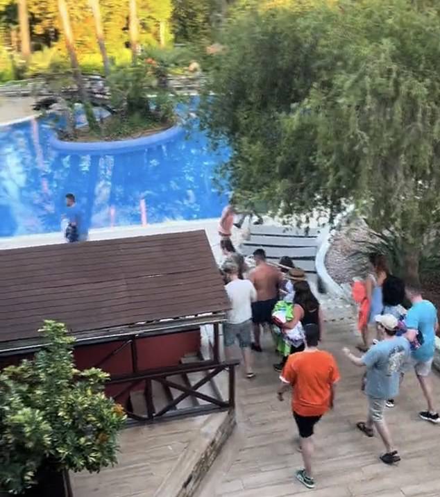 A separate video shows Britons running and pushing each other around the pool as they try to get the best spots.