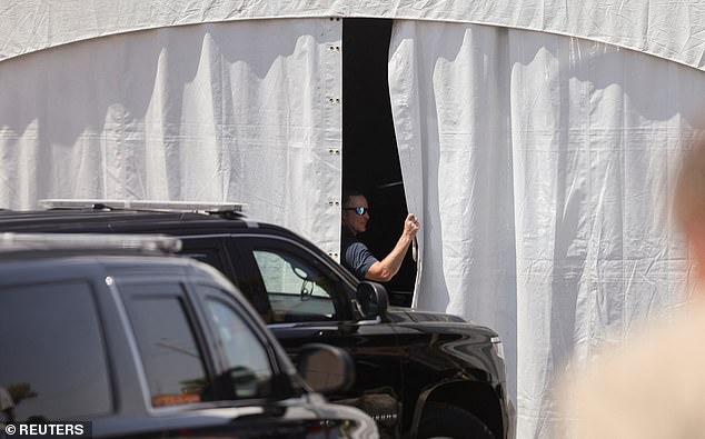 A US Secret Service agent opens the blinds housing the Beast presidential limousine in Las Vegas