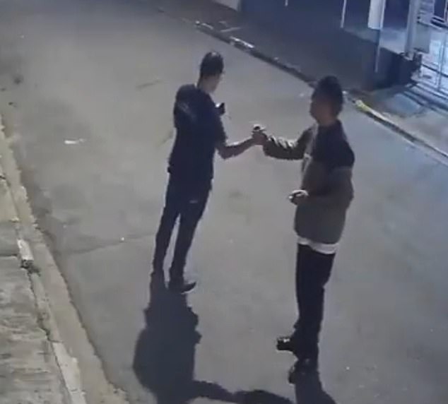 Otávio Ribeiro (left) shook hands with his friends after leaving work seconds before being assaulted by two suspects, including a 16-year-old boy whom he disarmed and shot dead.