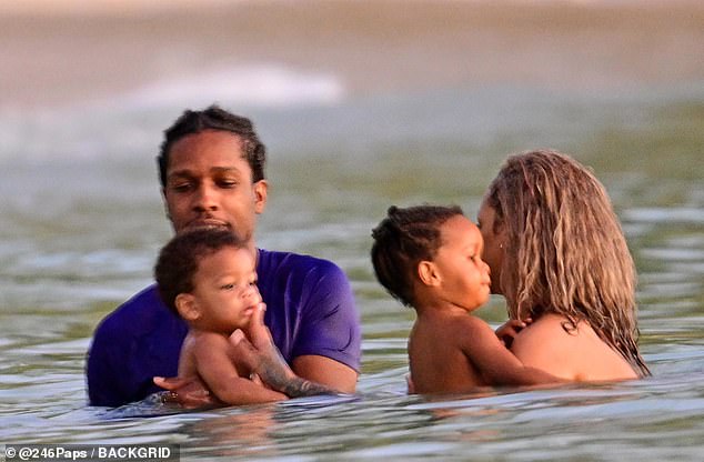 The family of four stayed close as they enjoyed the water together.