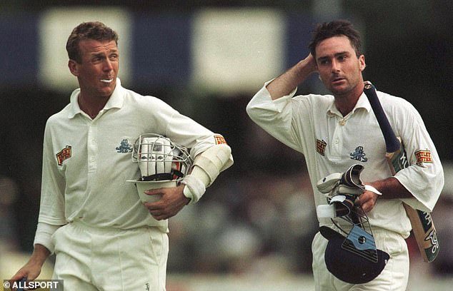 England's Graham Thorpe (right) and Alec Stewart walk off the field with their helmets, gloves and bats after registering a partnership of 150 on day four of the second Test match against Zimbabwe.