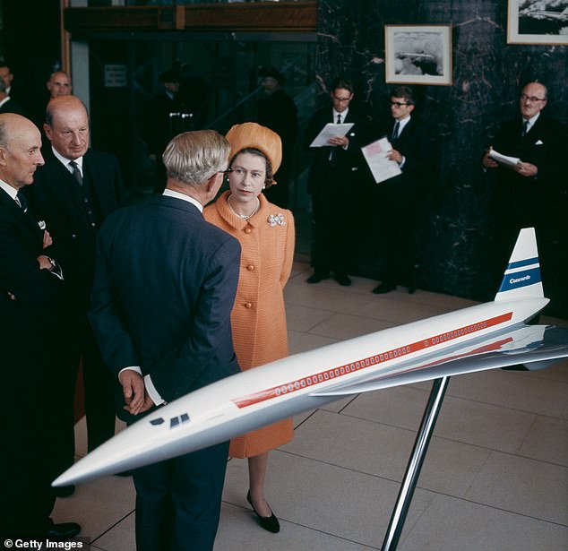 Queen Elizabeth II talks to businessmen in front of a model of the Concorde passenger aircraft at the British Aircraft Corporation's Filton, Bristol, September 1966