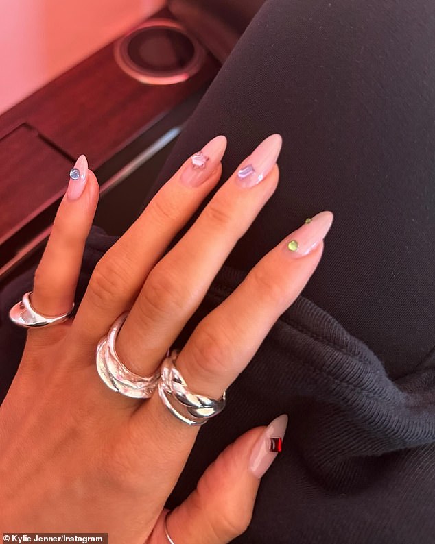 The reality star gave her followers a close-up of her flawless pale pink nails, which were a more modest length than she usually wears. She had multi-colored stones glued to her nails and sported multiple silver rings.