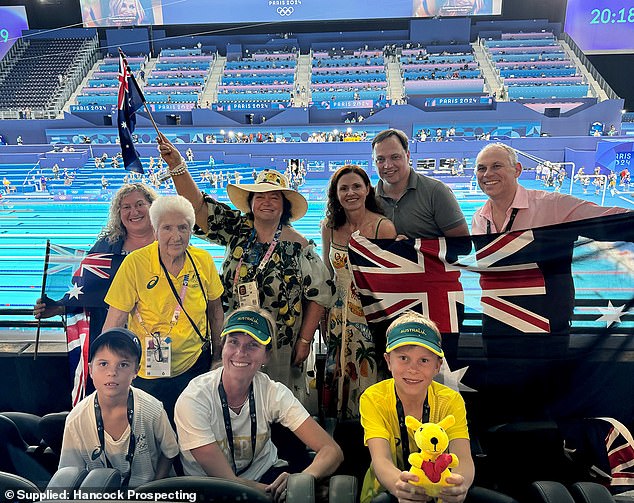 Ms Rinehart (pictured, third centre left) celebrates Australia's success in the pool alongside Olympic legend Dawn Fraser (pictured, right, centre left)