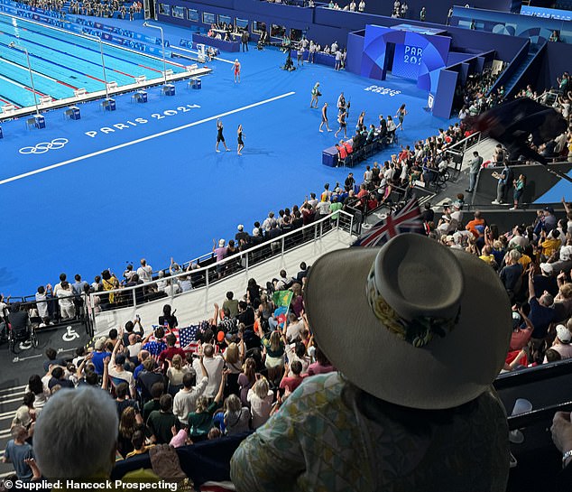 Australian gold medallist swimmers Mollie O'Callaghan and Shayna Jack greet Ms Rinehart in the stands.