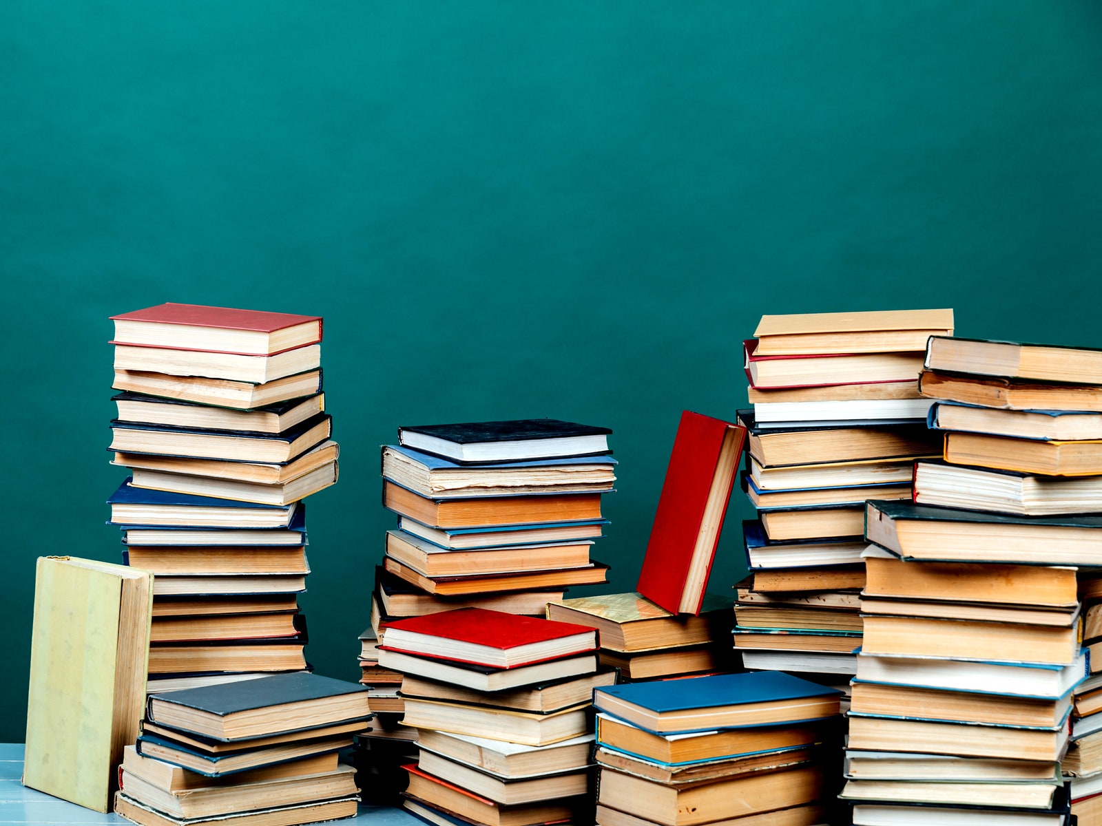 Stacks of used books on a green background