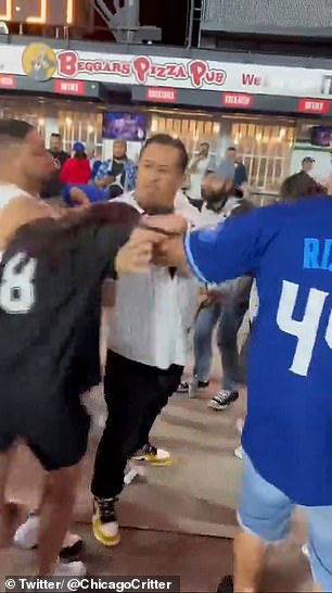 Men in Cubs and White Sox uniforms attempted to intervene, but things quickly escalated from there.