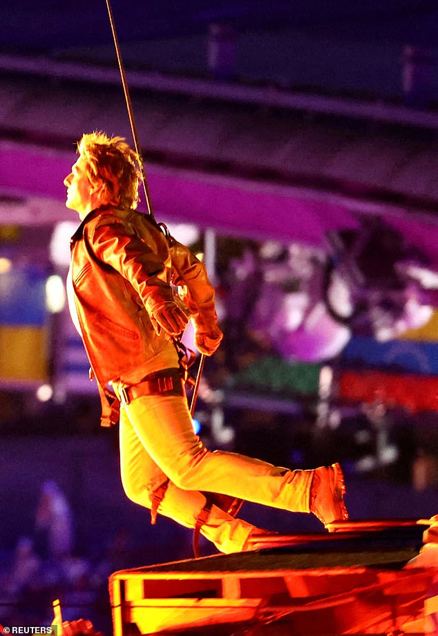 The 62-year-old star leapt from the roof of the Stade de France on Sunday night in a stunning display.