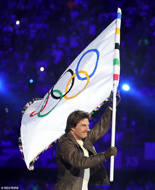 The actor held the Olympic flag during the dramatic closing ceremony in Paris