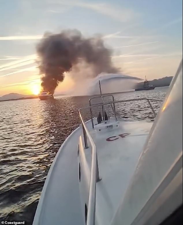 Images from the Olbia Coast Guard show the yacht sinking while being sprayed with a fire extinguisher