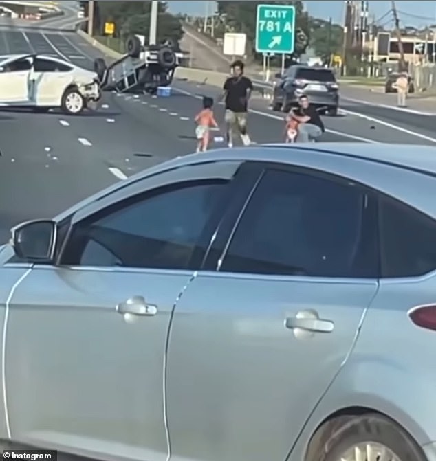 As the two boys were stranded in the middle of the 14-lane highway, two men can be seen running towards them and grabbing them as they call for help.