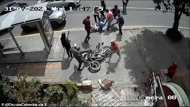 Bystanders took turns trying to destroy a motorcycle while the person riding it, a suspected assailant, was savagely beaten in Bogotá, Colombia, on July 31.