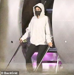 They both opted to wear black exam-style face masks, with Kylie opting for a loose white sweatshirt with black leggings.