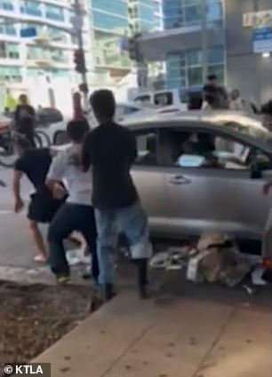 Teenagers attack his car in downtown Los Angeles