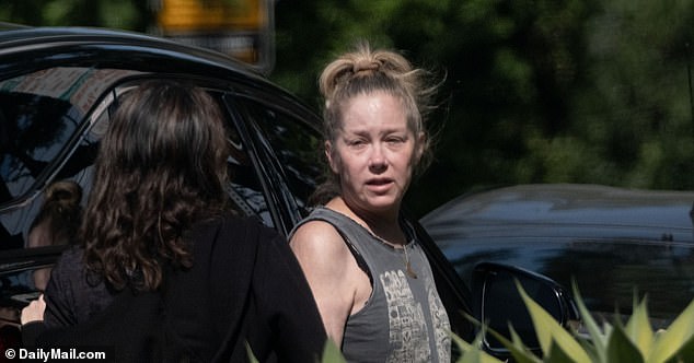 Exclusive photos from DailyMail.com show Applegate stopping for a smoke outside her car ahead of a date near Hollywood.