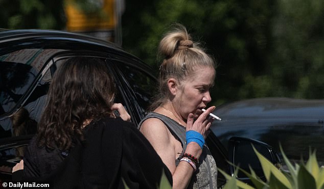 She had her hair tied back in a loose bun and was wearing a grey sleeveless T-shirt with a pattern on it. She was also seen sporting a blue bandage around her right hand.