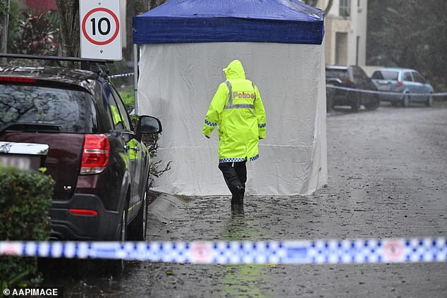 Police are seen at the scene of the young woman's death in Carrara on the Gold Coast on Wednesday.