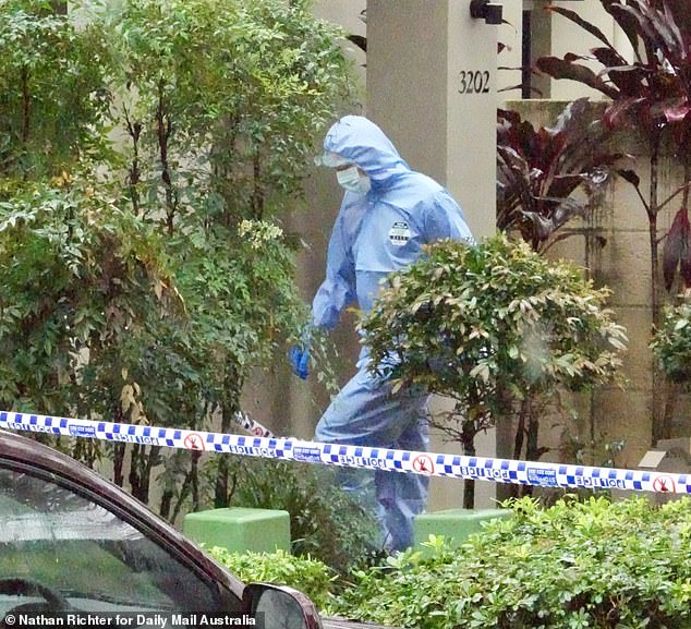 Forensic officers are seen arriving at the home in Carrara on Wednesday after the alleged murder.