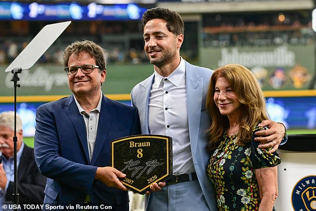 Attanasio, pictured with the Brewers' Ryan Braun and his wife Debbie, bought his baseball team in 2004 and took control of English soccer club Norwich City on Monday.