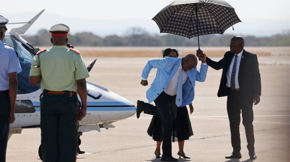 Botswana's president dances on the airport runway before greeting the country's athletes on their way home.